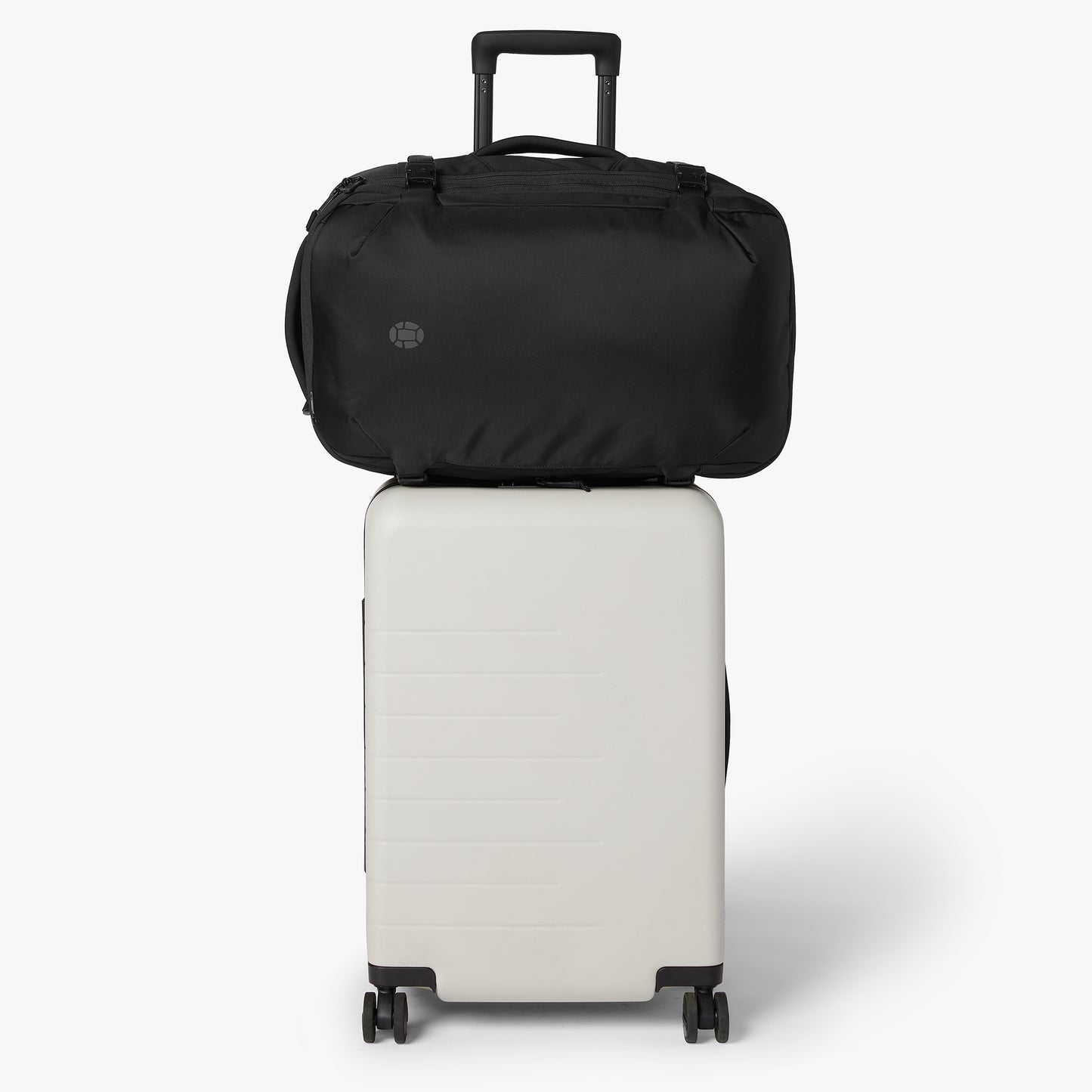 Luggage handle pass-through for hands-free carry on a suitcase.